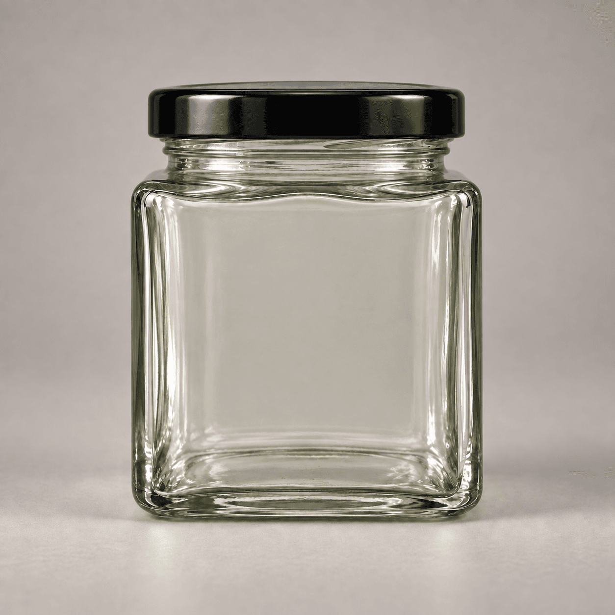 Ash & Ember — square glass jar with ivory wraparound label and centred bronze tamper seal